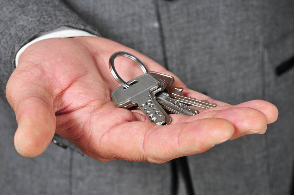 Property keys held in hand after a successful eviction in Dallas-Fort Worth, Texas