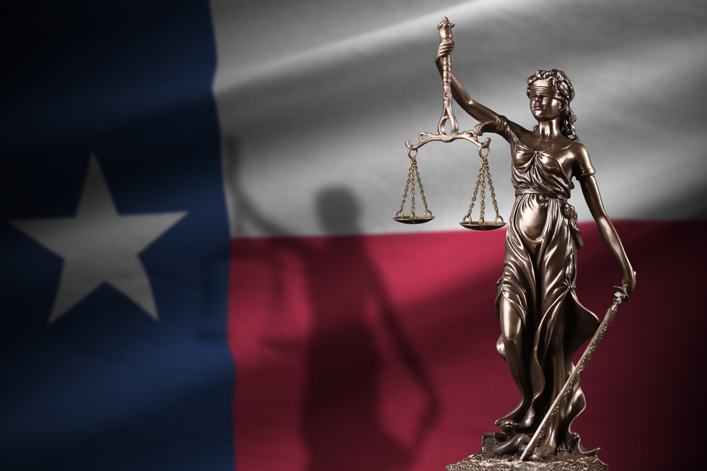 Lady Justice statue with Texas flag representing the Dallas County eviction court system
