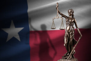 Texas flag with a statue of the legal system in Dallas