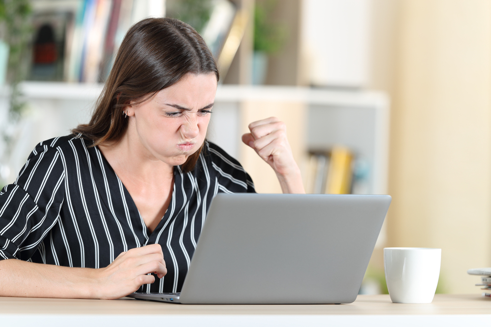 A Dallas landlord in front of laptop angry that she did a mistake with sending the eviction notice